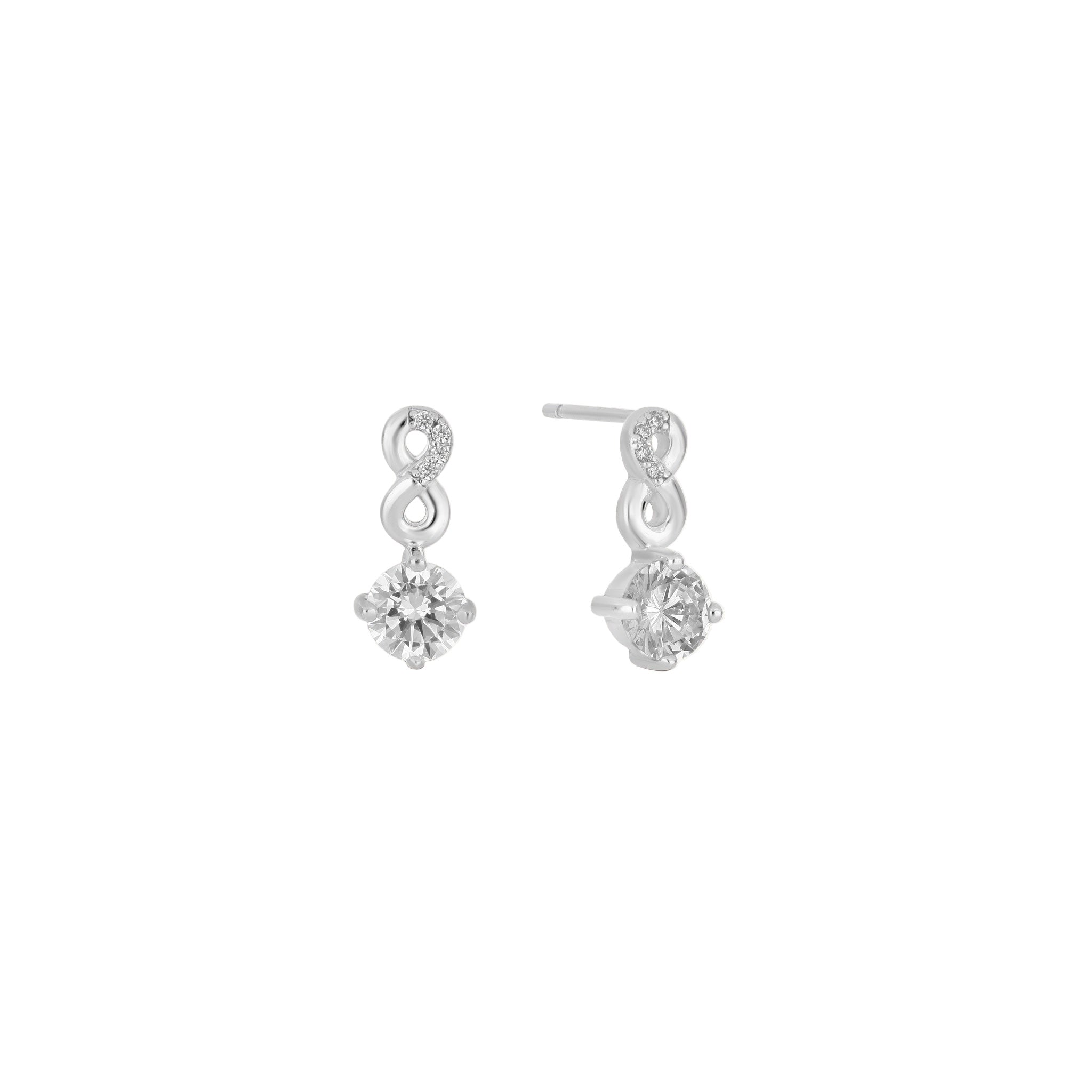 Pair of silver earrings with clear gemstones on a white background
