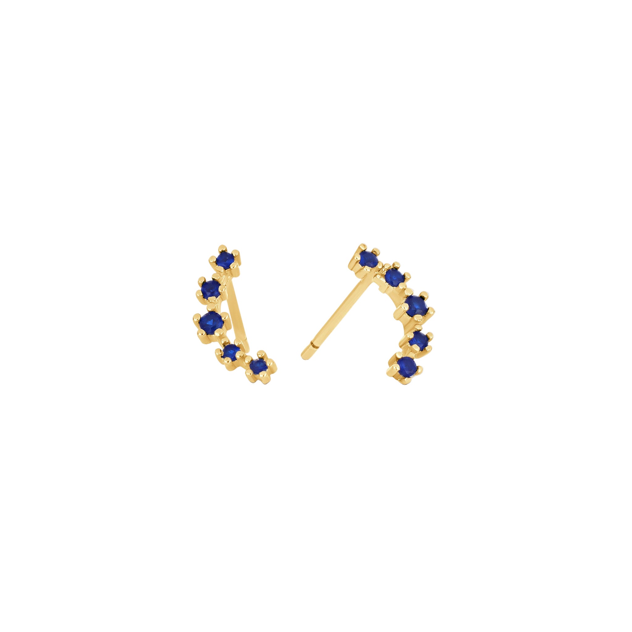 Gold earrings with blue gemstones on a white background